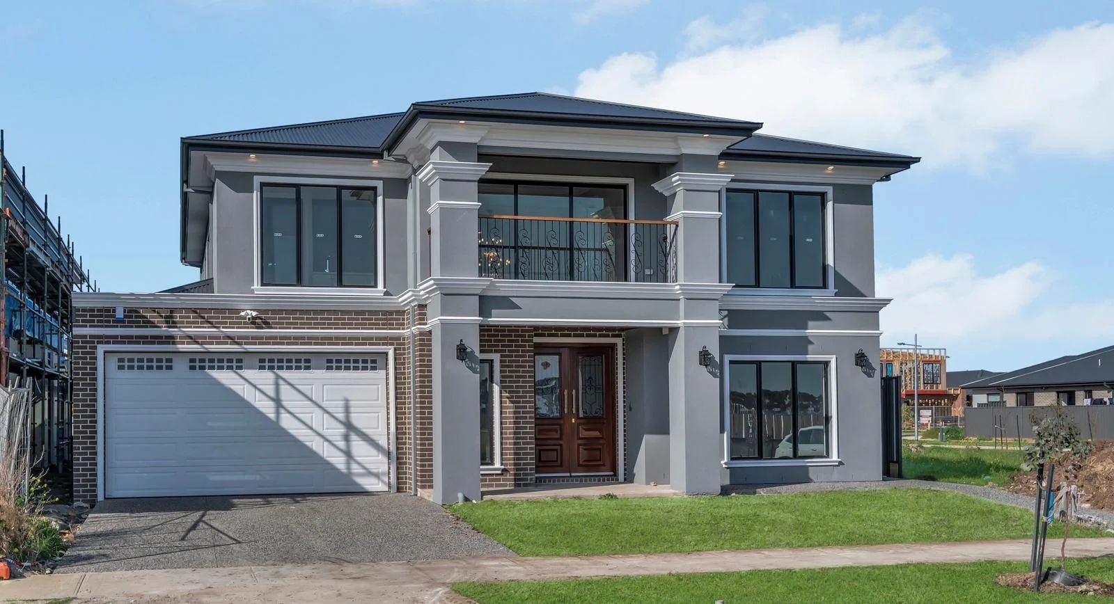 Double storey rendered home with brick garage