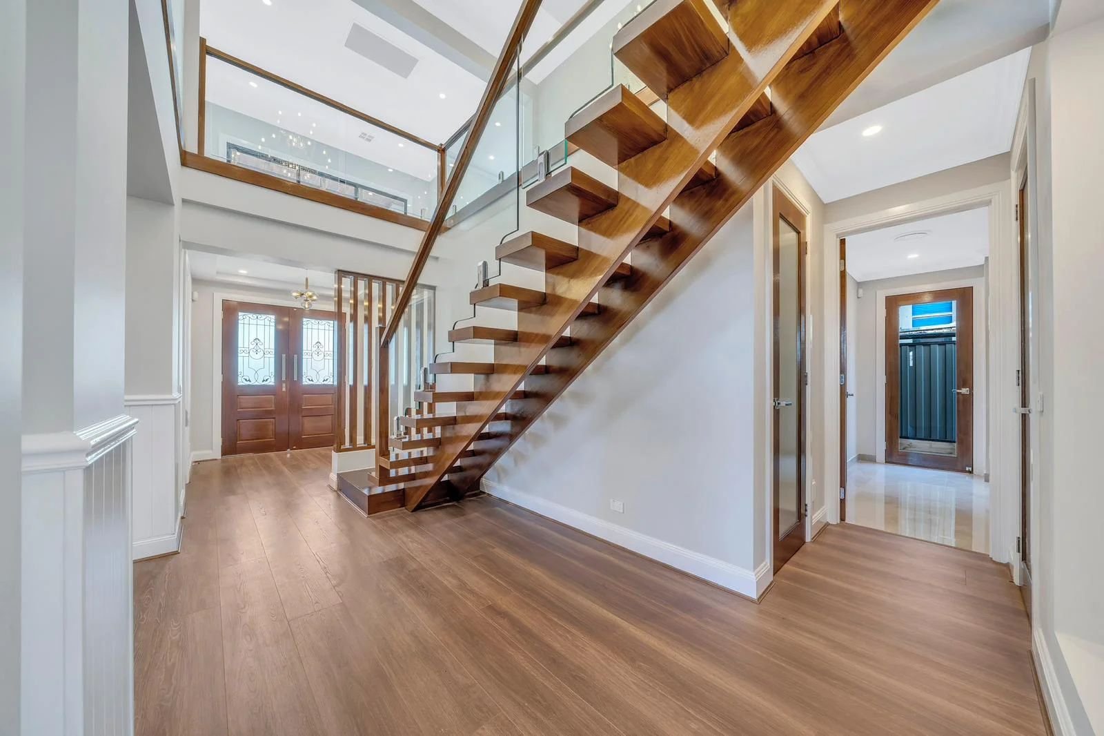 Floating timber staircase with glass balustrade